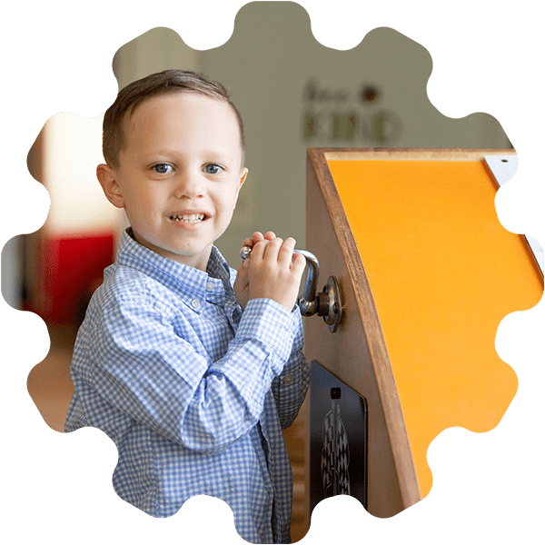 boy playing with a wind up box