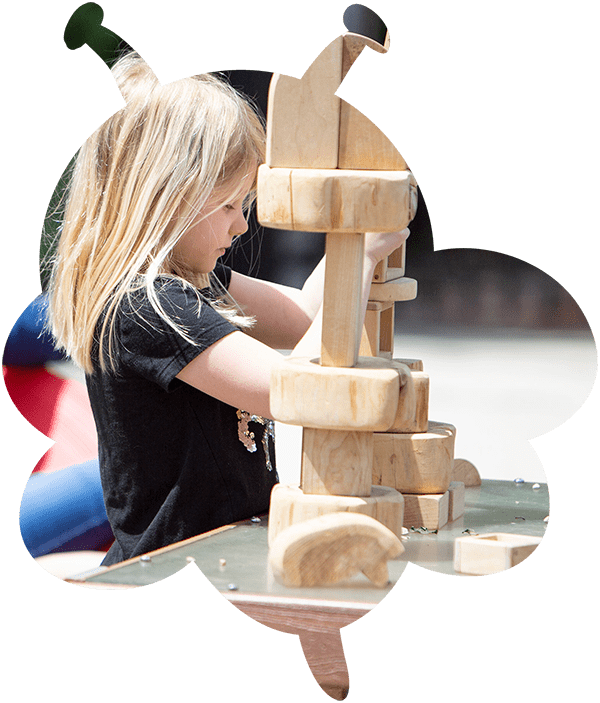 girl playing with blocks outdoors